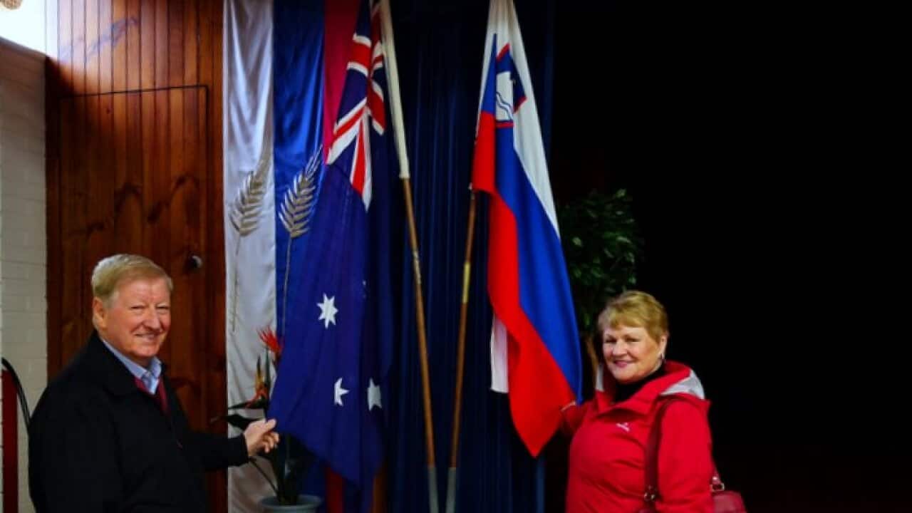 Stanko Prosenak and Anica Markič with Slovenian and Australian flags at Slovenian mission in Kew, Melbourne