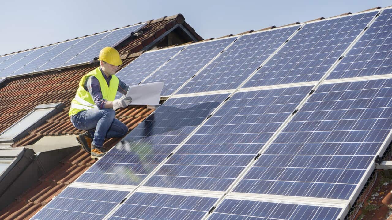 Engineer on roof controlling solar panels
