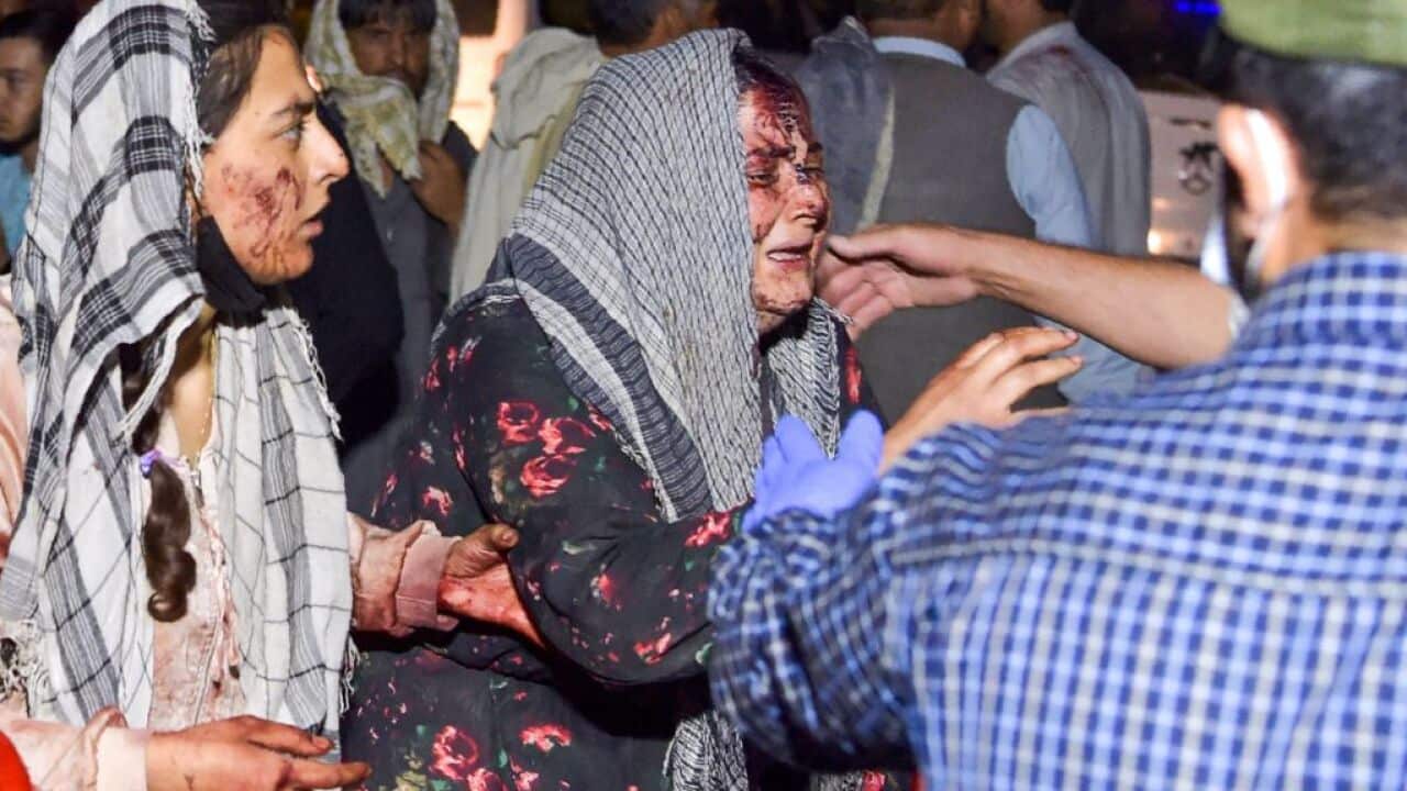 Wounded women arrive at a hospital for treatment after the Kabul blasts, claimed by ISIS-K