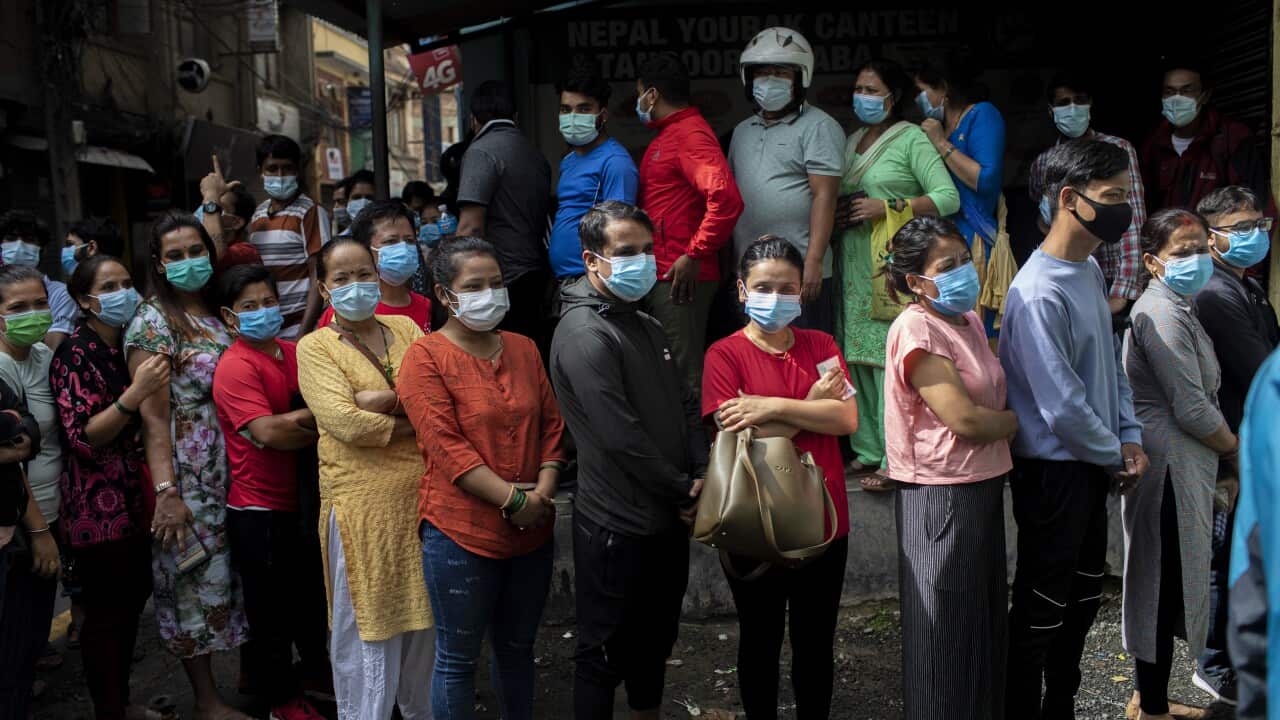 A group of women line up to receive a dose of Shinopharm Vero cell COVID-19 vaccine in Kathmandu, Nepal. 31 July 2021.