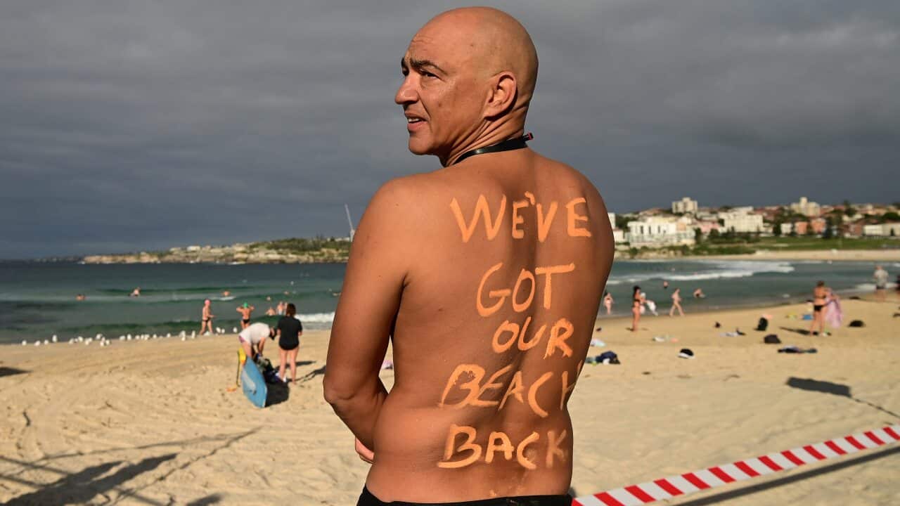 David Wesson poses as Bondi Beach reopens to the public after closing following an outbreak of coronavirus.