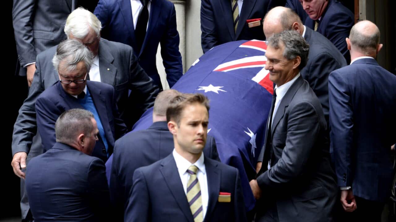 Former prime minister Malcolm Fraser is carried from the church AAP