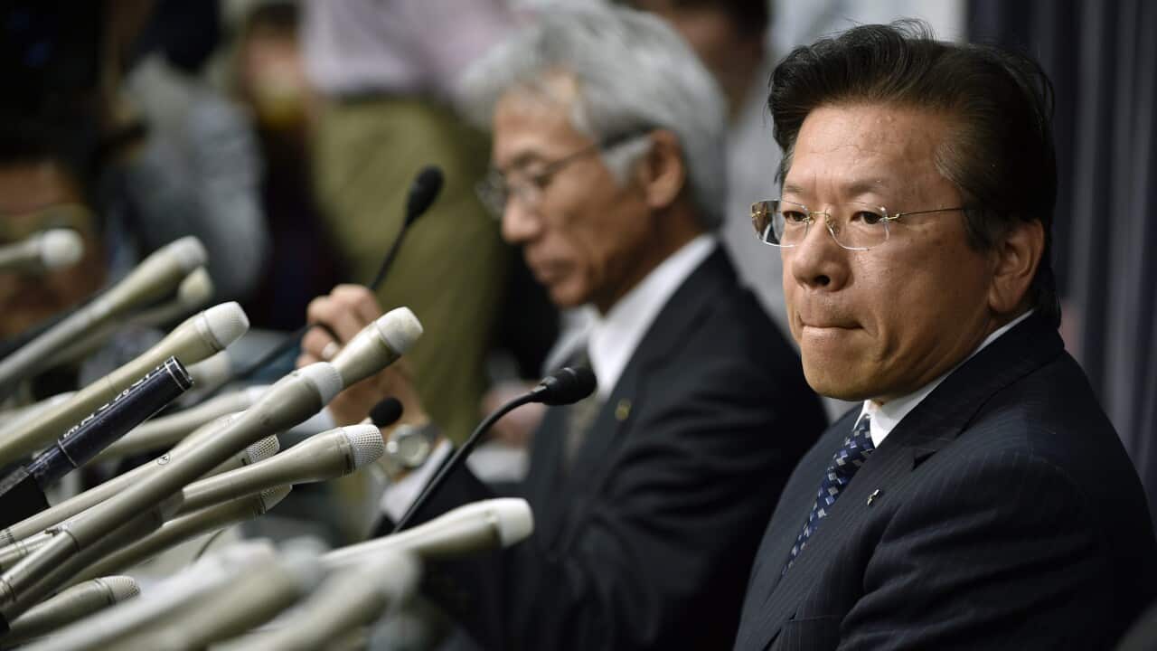 Mitsubishi Motors Corp's President Tetsuro Aikawa (right) attends a press conference regarding irregular fuel efficiency tests by the carmaker.
