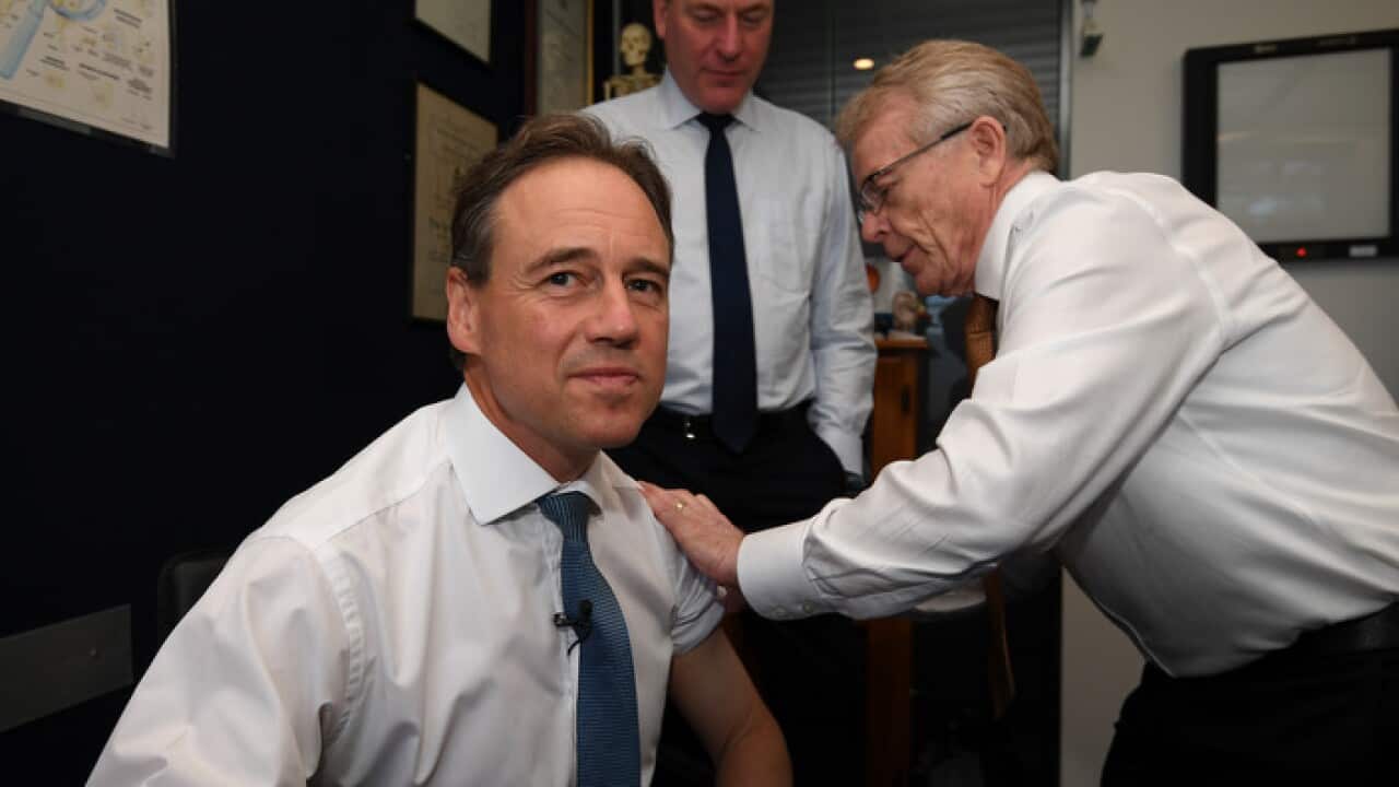 Federal Health Minister Greg Hunt receiving last year’s flu vaccine from Dr Brian Morton