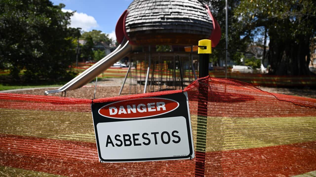 Children’s playground equipment and picnic areas are seen fenced off at Sydney Bicentennial Park, with Danger Asbestos sign.