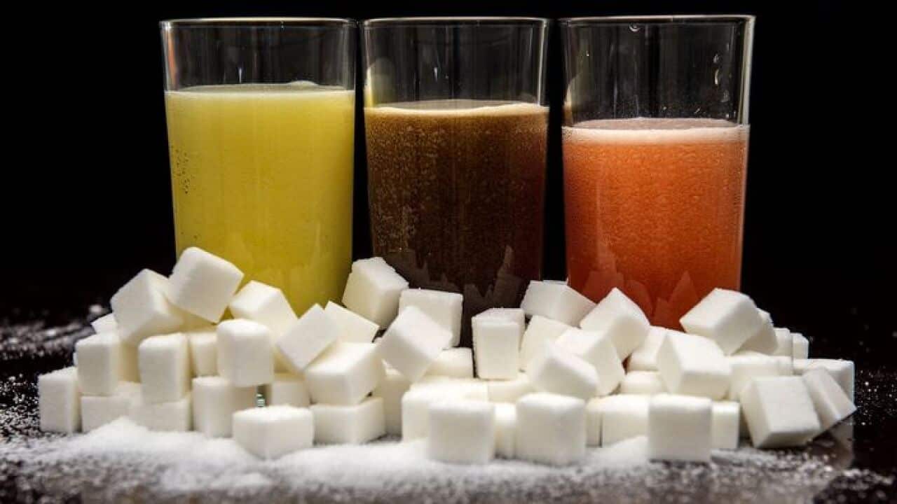 Sugary drinks next to sugar cubes.