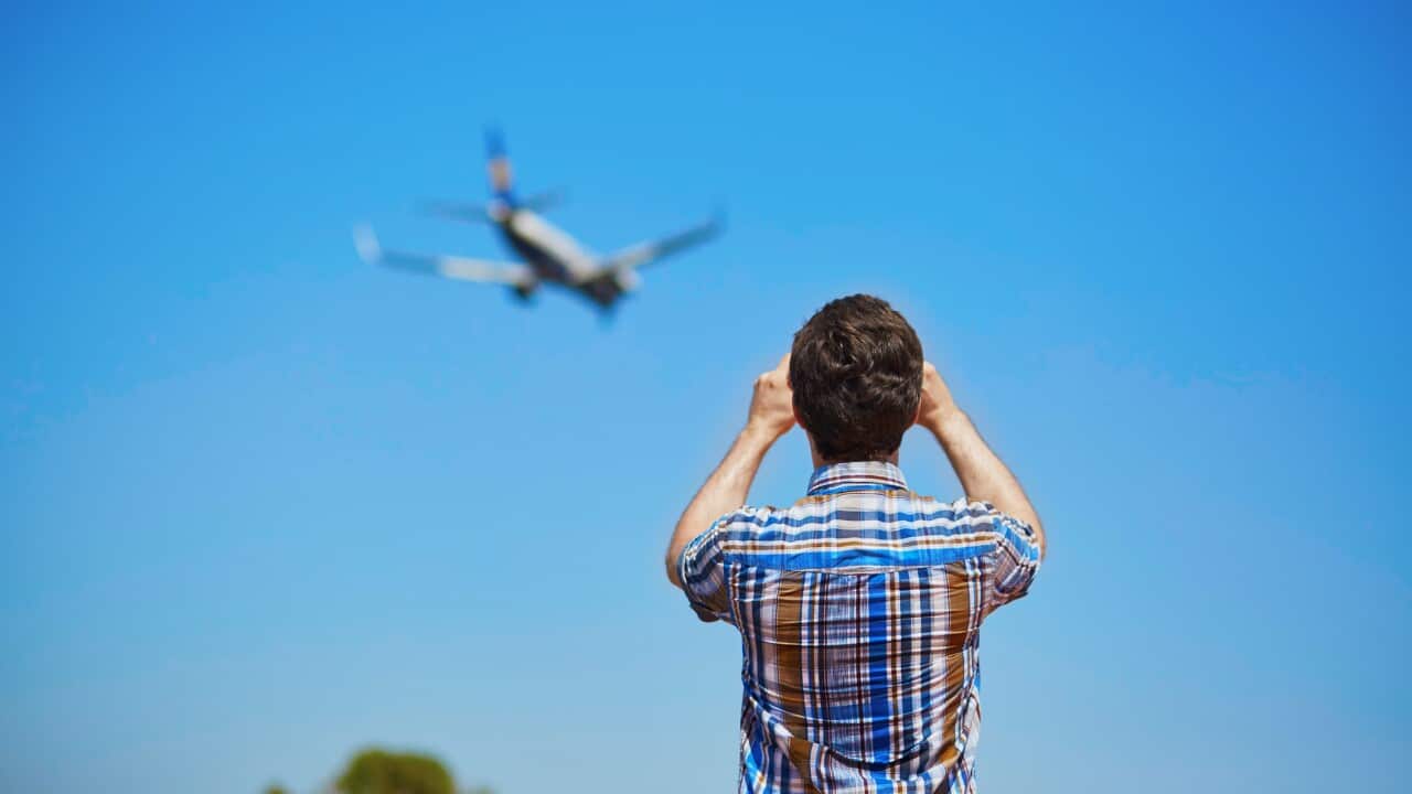 Man is looking at the glide path and landing plane