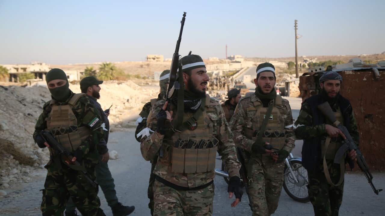 A group of men in military clothing carrying guns