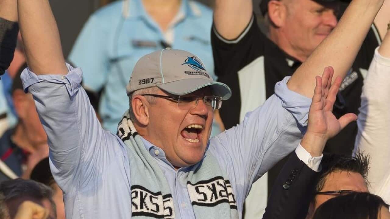 Scott Morrison celebrates a Sharks try during a match on Sunday.