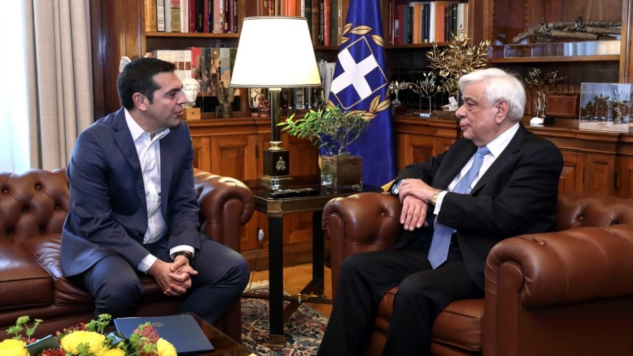 Greek President Prokopis Pavlopoulos, right, listens to Prime Minister Alexis Tsipras during a meeting at the presidential palace in Athens