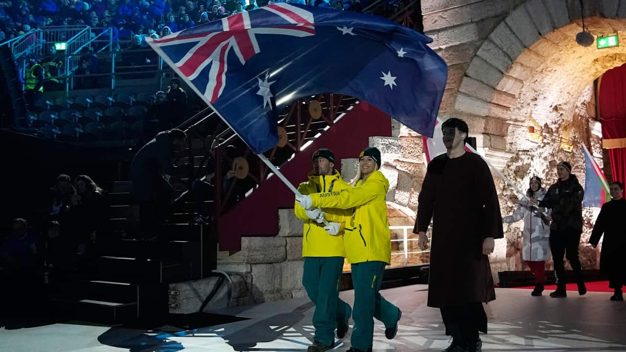 Danielle Scott and Cooper Woods, of Australia, carry their country's flag during the closing ceremony of the 2026 Winter Olympics, in Verona, Italy, Sunday, Feb. 22, 2026.