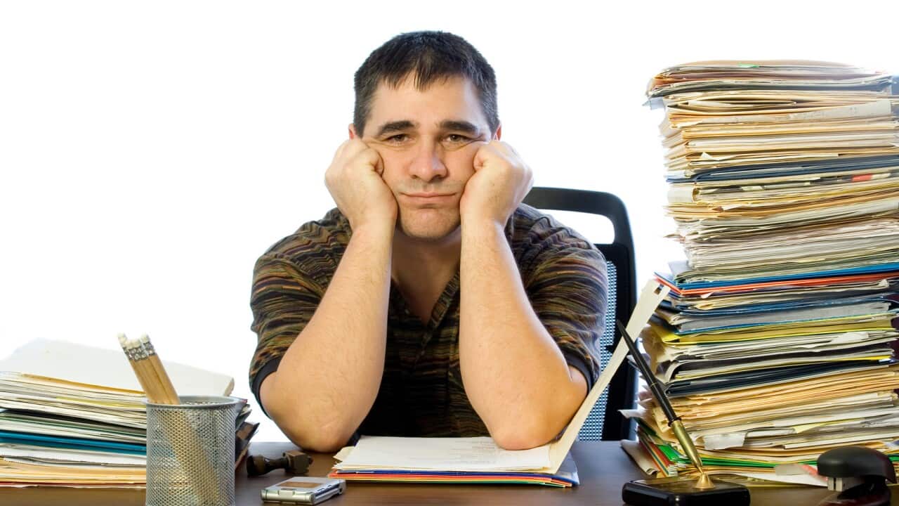 Sad man at desk after not being paid full super contributions