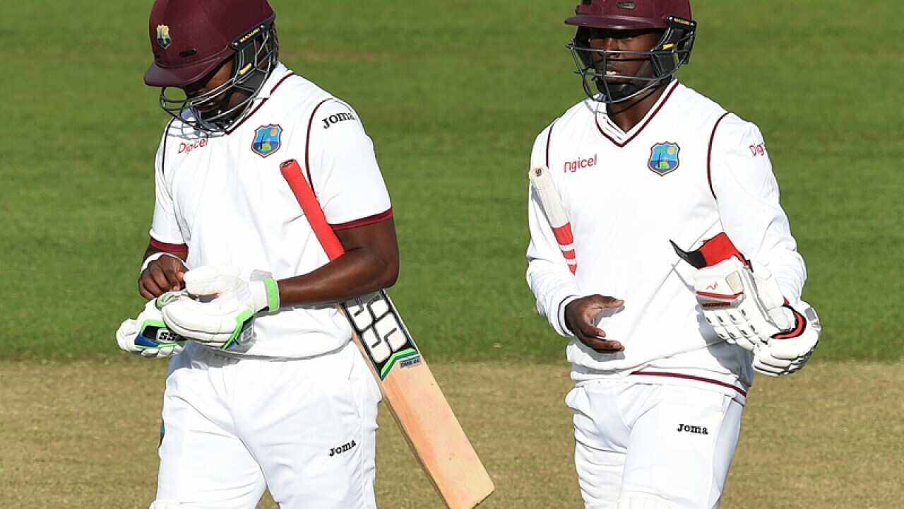 West Indies batsmen Darren Bravo (L) and Kemar Roach