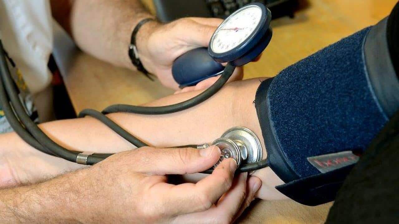 Dr Laurence Buckman checks a patient's blood pressure.