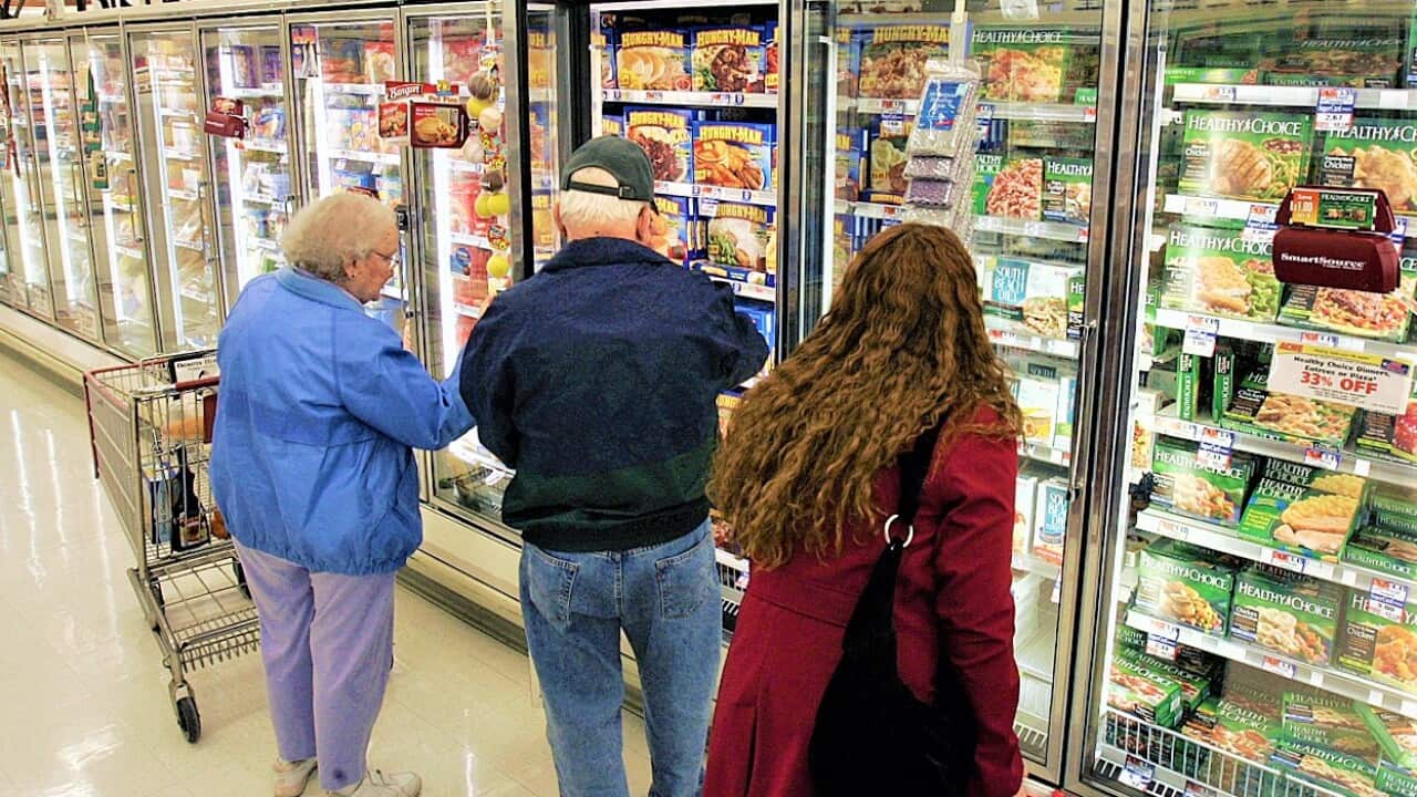 Shoppers look through the frozen foods section
