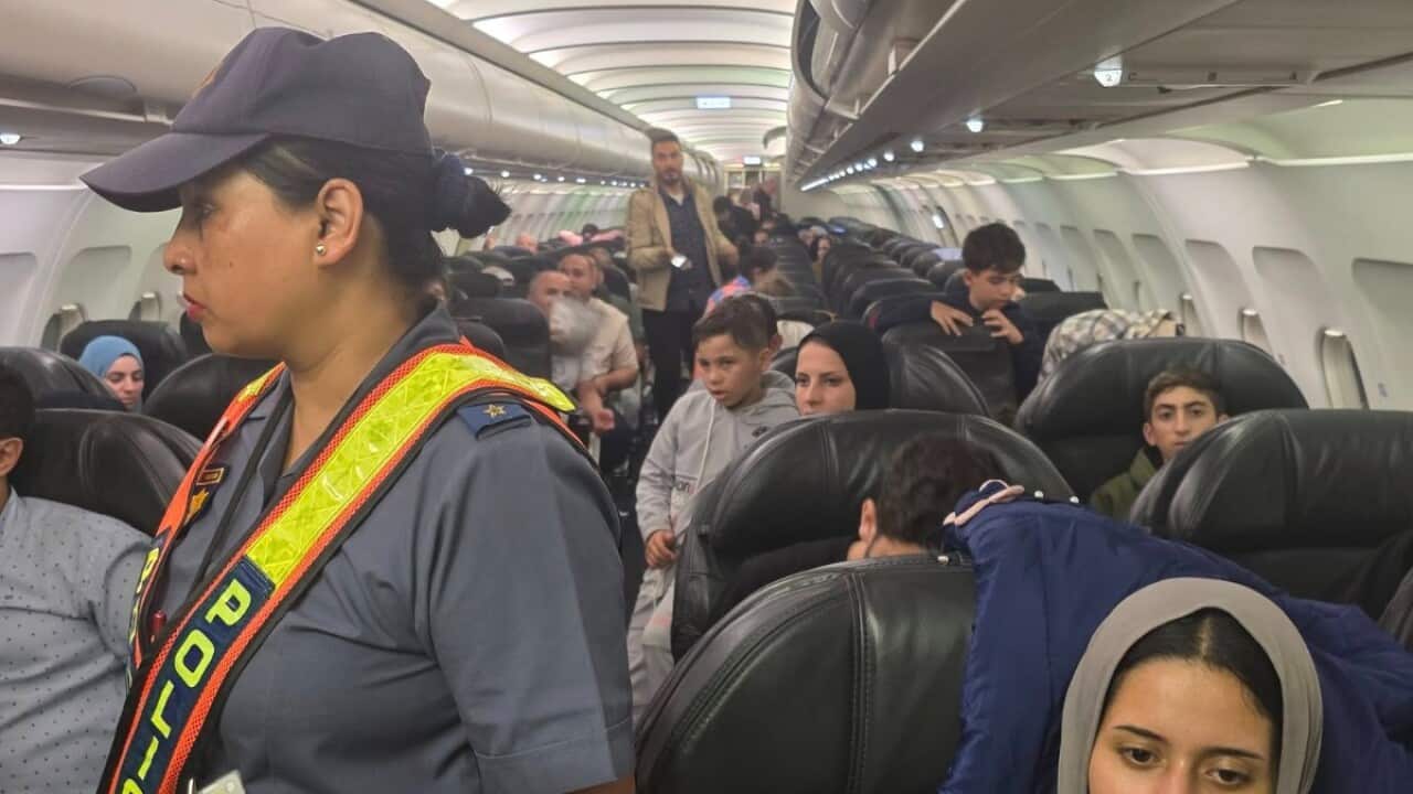 A group of people inside the cabin of an airplane