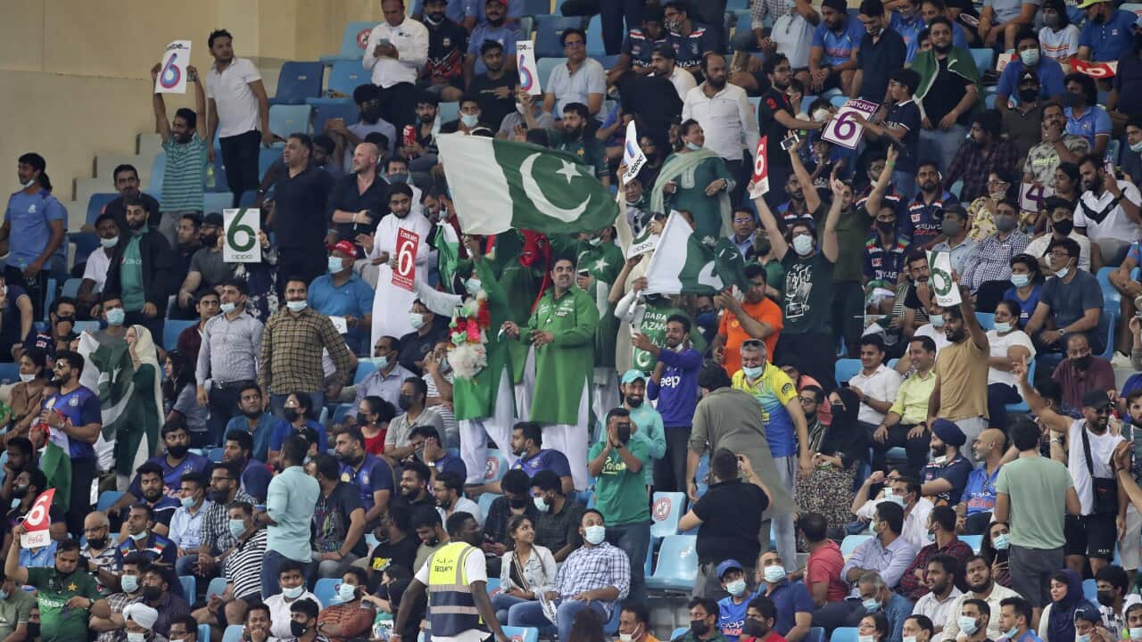Pakistan's cricket fans celebrate a six by captain Babar Azam during the Cricket Twenty20 World Cup match between India and Pakistan in Dubai, UAE, Sunday, Oct. 24, 2021. (AP Photo/Aijaz Rahi)