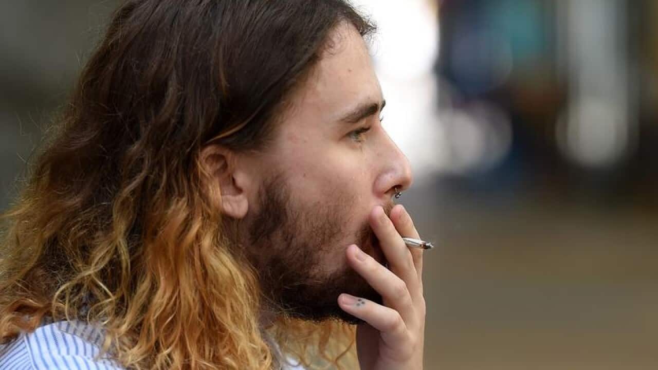 A man smokes during lunchtime in central Brisbane.