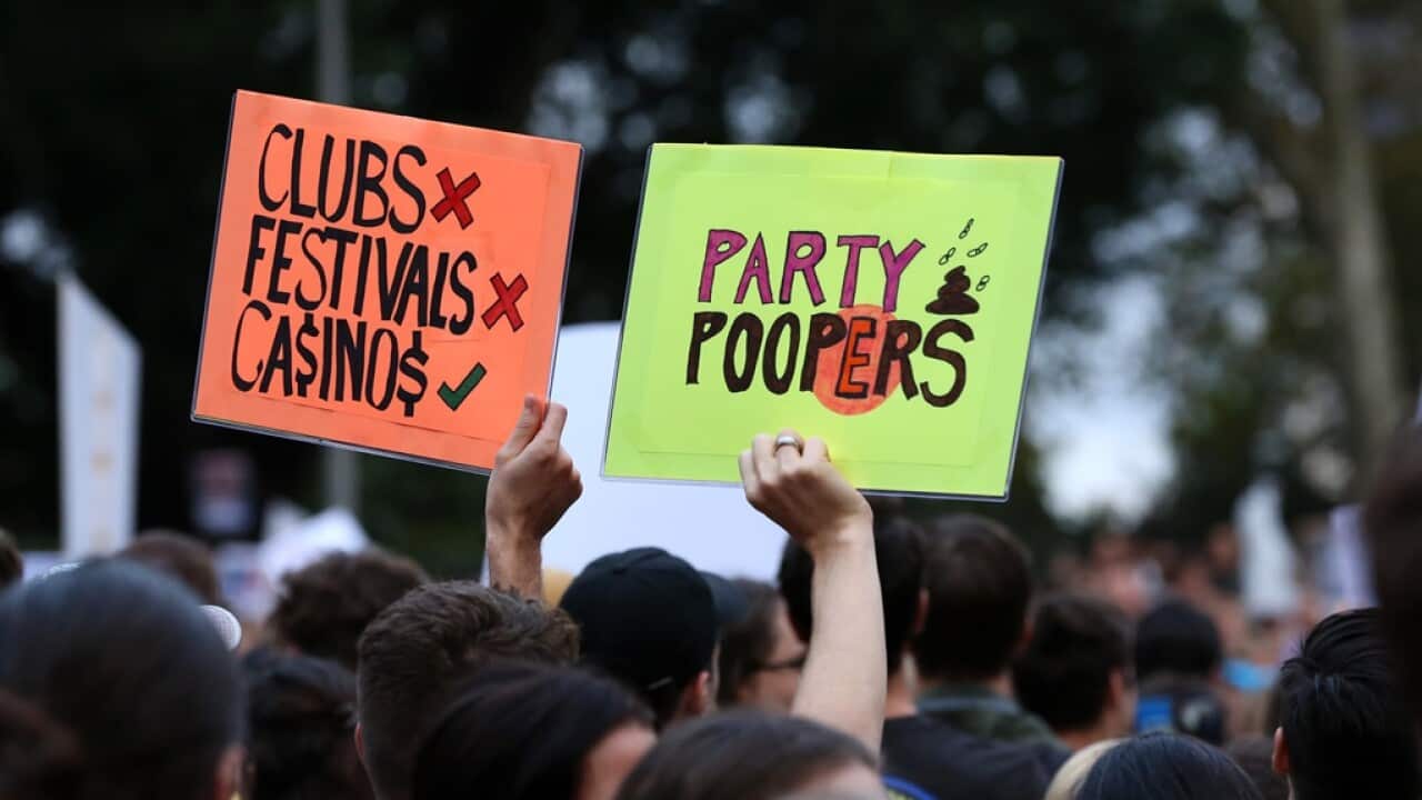 Protestors hold signs during the Don't Kill Live Music Rally in Sydney
