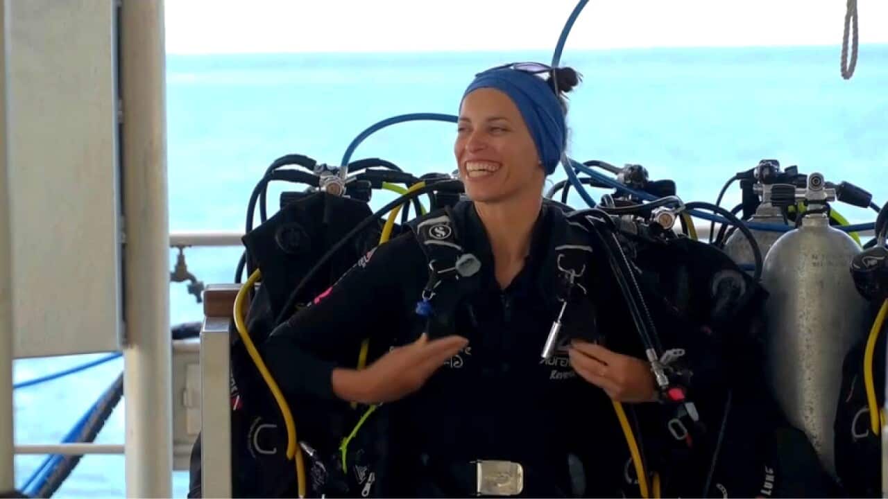 Dive leader Anais Maurer prepares to lead tourists underwater