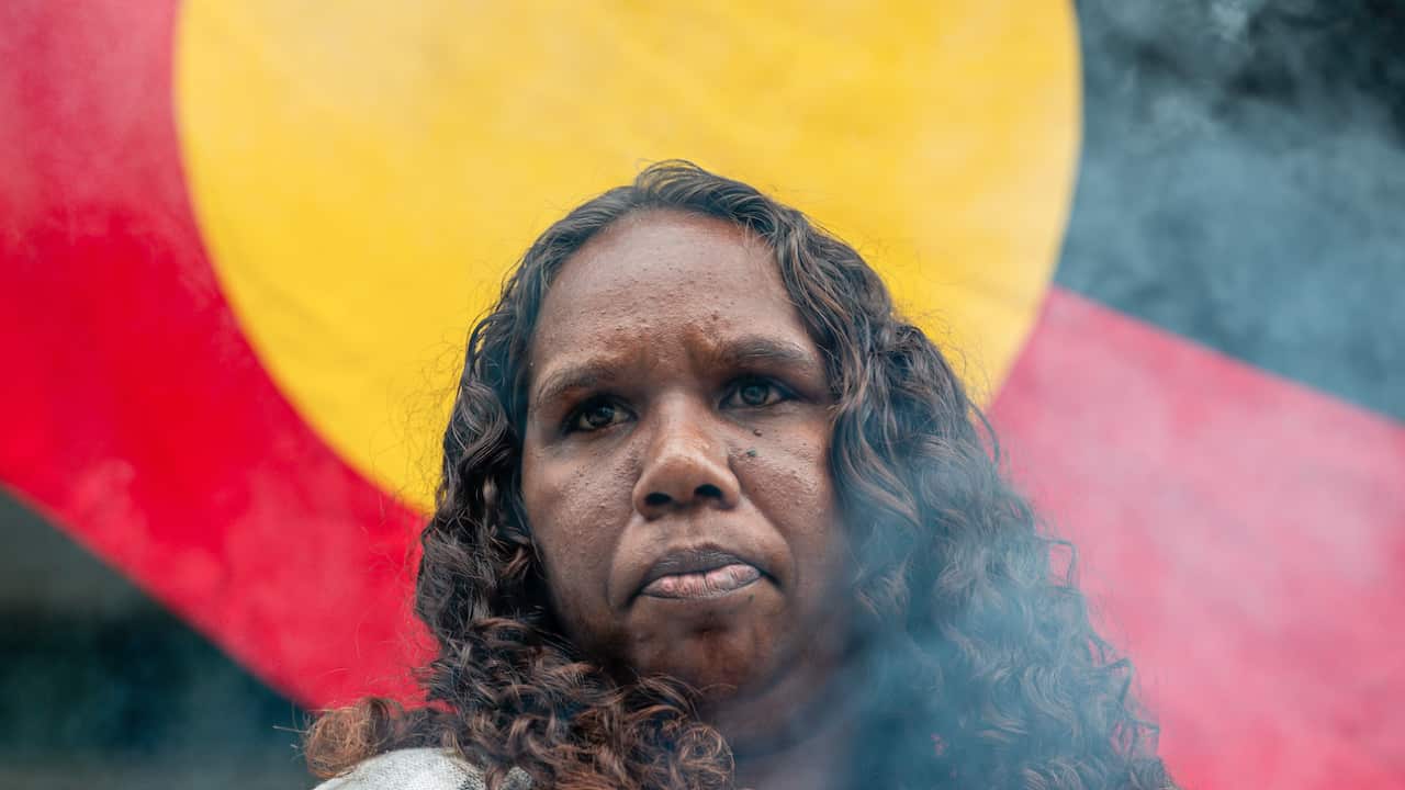 A supporter of the woman referred to as 'JC' outside the court in Perth