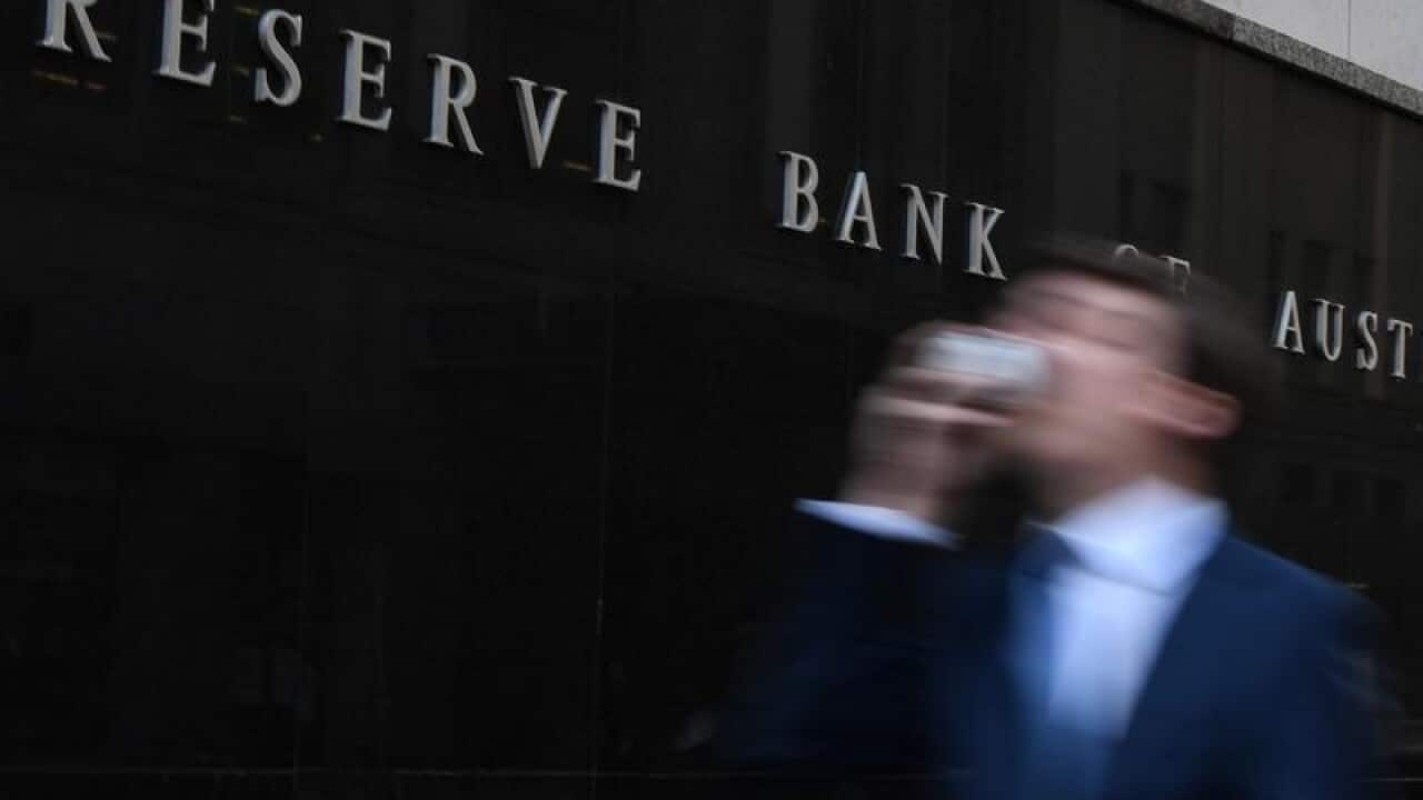 A man walks past the Reserve Bank of Australia building in Sydney.