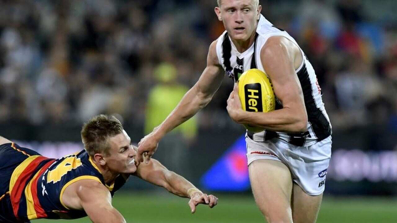 Jaidyn Stephenson of the Magpies gets away.