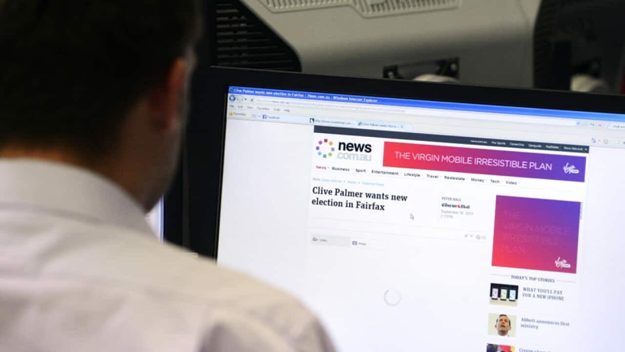 A man uses a desktop computer