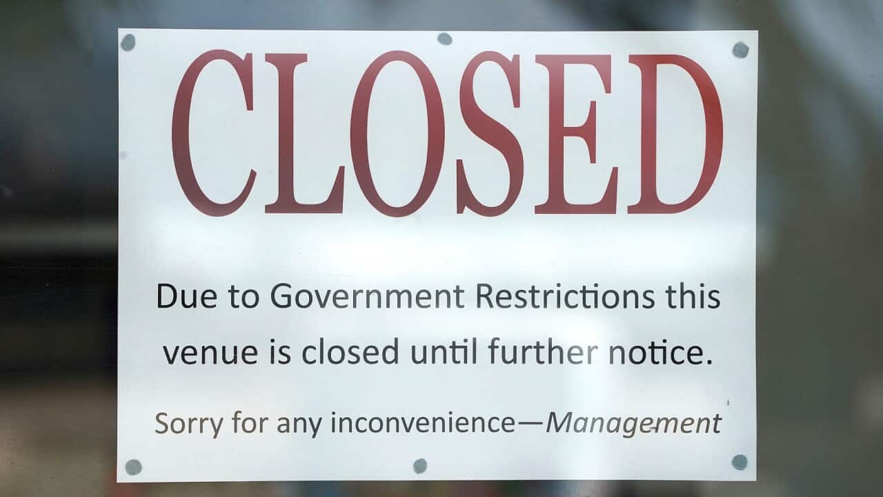 A closed sign is seen at Surfers Paradise business on the Gold Coast, Wednesday.