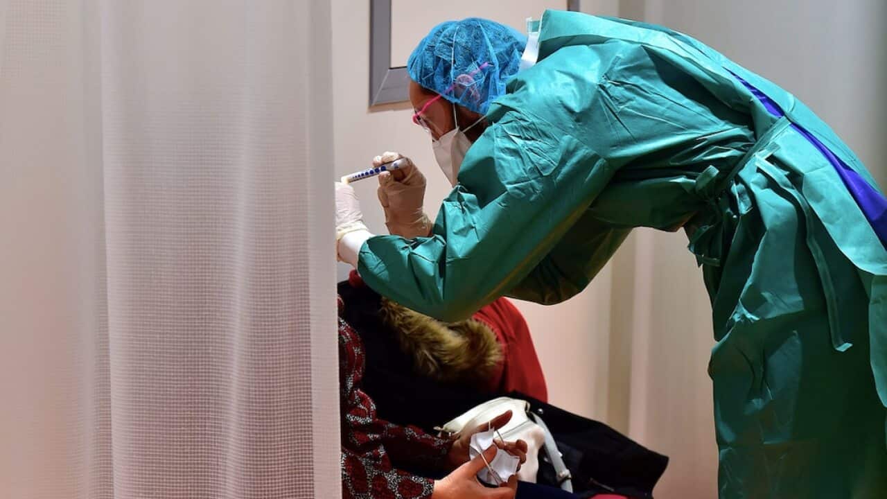 A doctor examines a patient during the COVID-19 ourbreak.