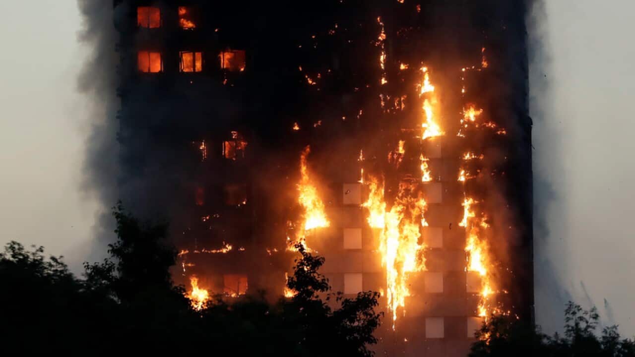 Smoke and flames rise from the Grenfell Tower building on fire in London in 2017