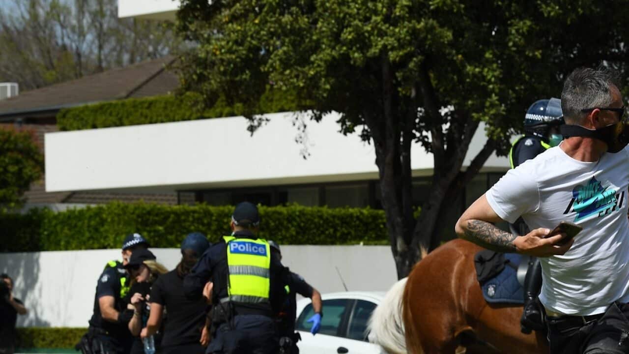 Protesters run from Victoria Police following a protests in Elsternwick Park in Melbourne.