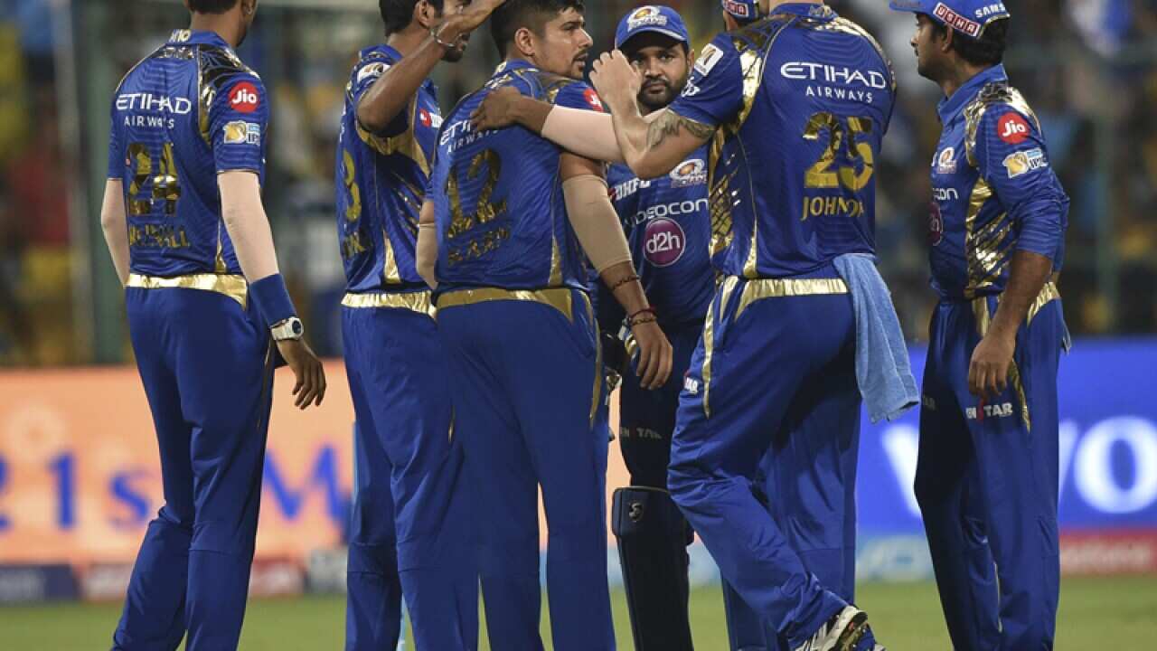 Mumbai Indians players celebrate the wicket of Sunil Narine