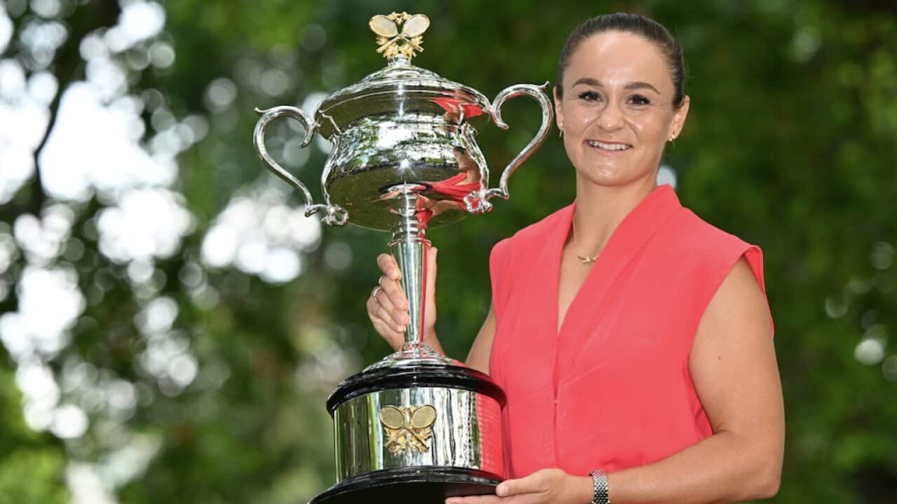 Ash Barty poses for a photograph with the Daphne Akhurst Memorial Cup a day after winning the Women’s singles final of the Australian Open, Sunday 30 January 2022.