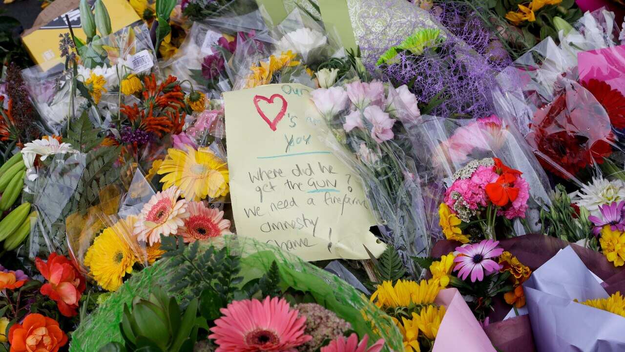 A handwritten message is placed at a makeshift memorial near the Masjid Al Noor mosque in Christchurch.