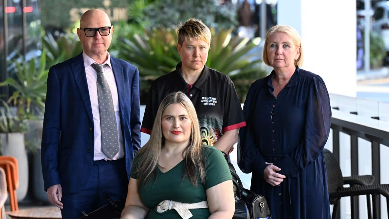 Disability advocates stand next to each other for a group photo.