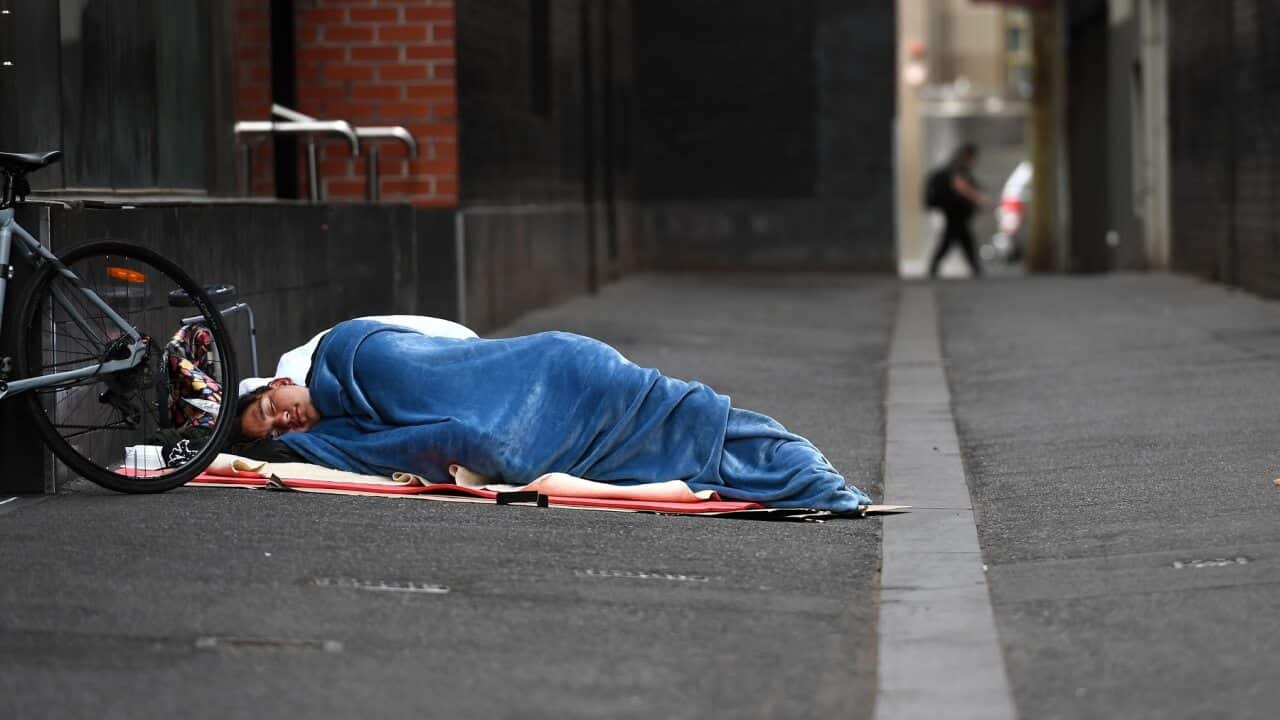 A homeless man sleeps in a laneway in Melbourne