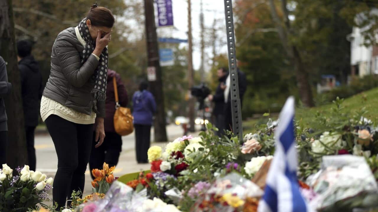 A person mourns at a makeshift memorial at the Tree of Life Synagogue in Pittsburgh.