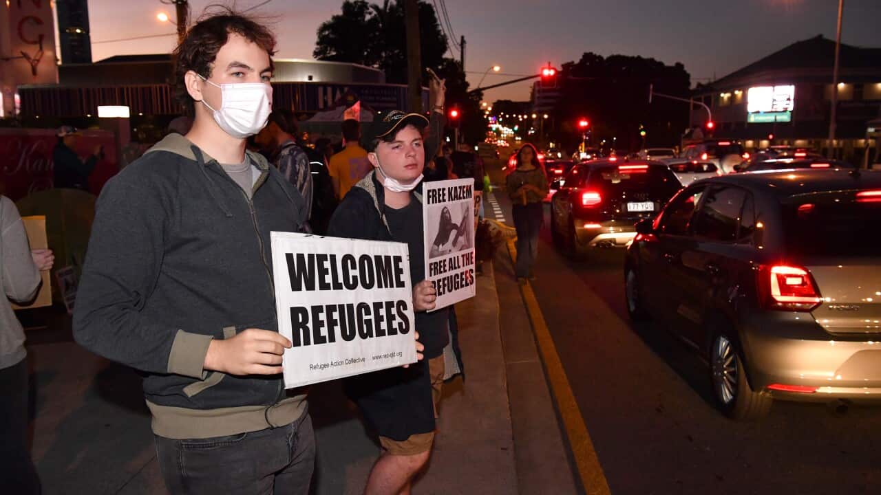 Protestors are seen outside the Kangaroo Point Central Hotel in Brisbane, Friday 12 June.