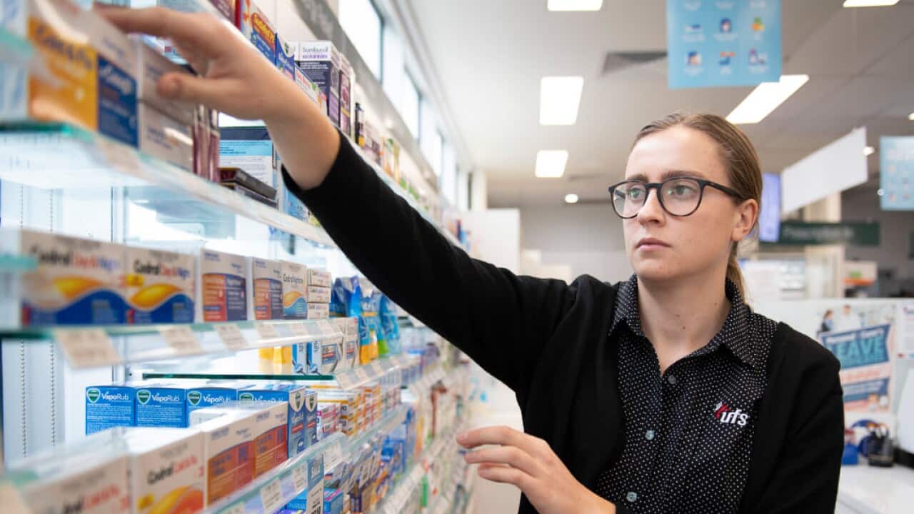 Pharmacist reaches for medicine in Melbourne