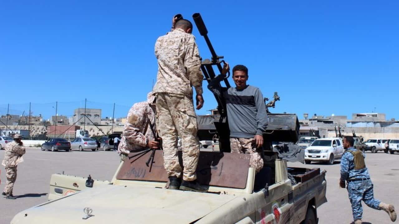 Militants gather before heading to the frontline to join forces defending the capital, in Tripoli