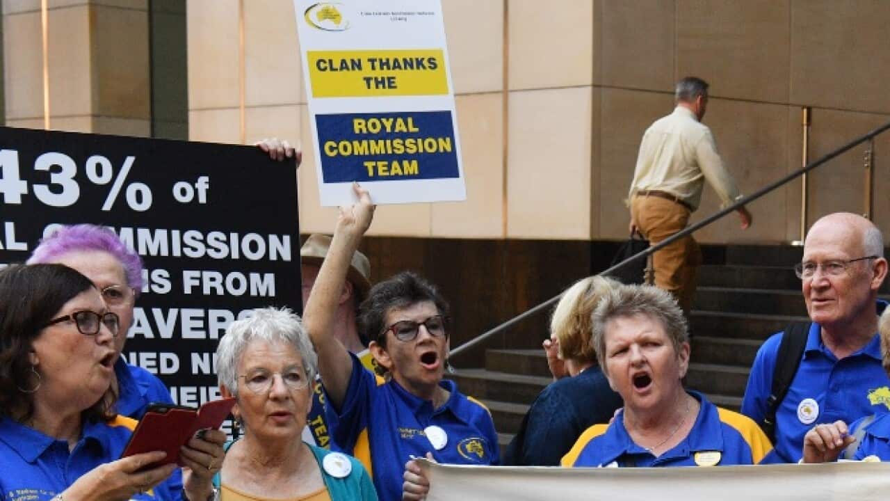 Supporters of the victims of child sexual abuse are seen outside at the final public hearing to mark the end of the Royal Commission (AAP)