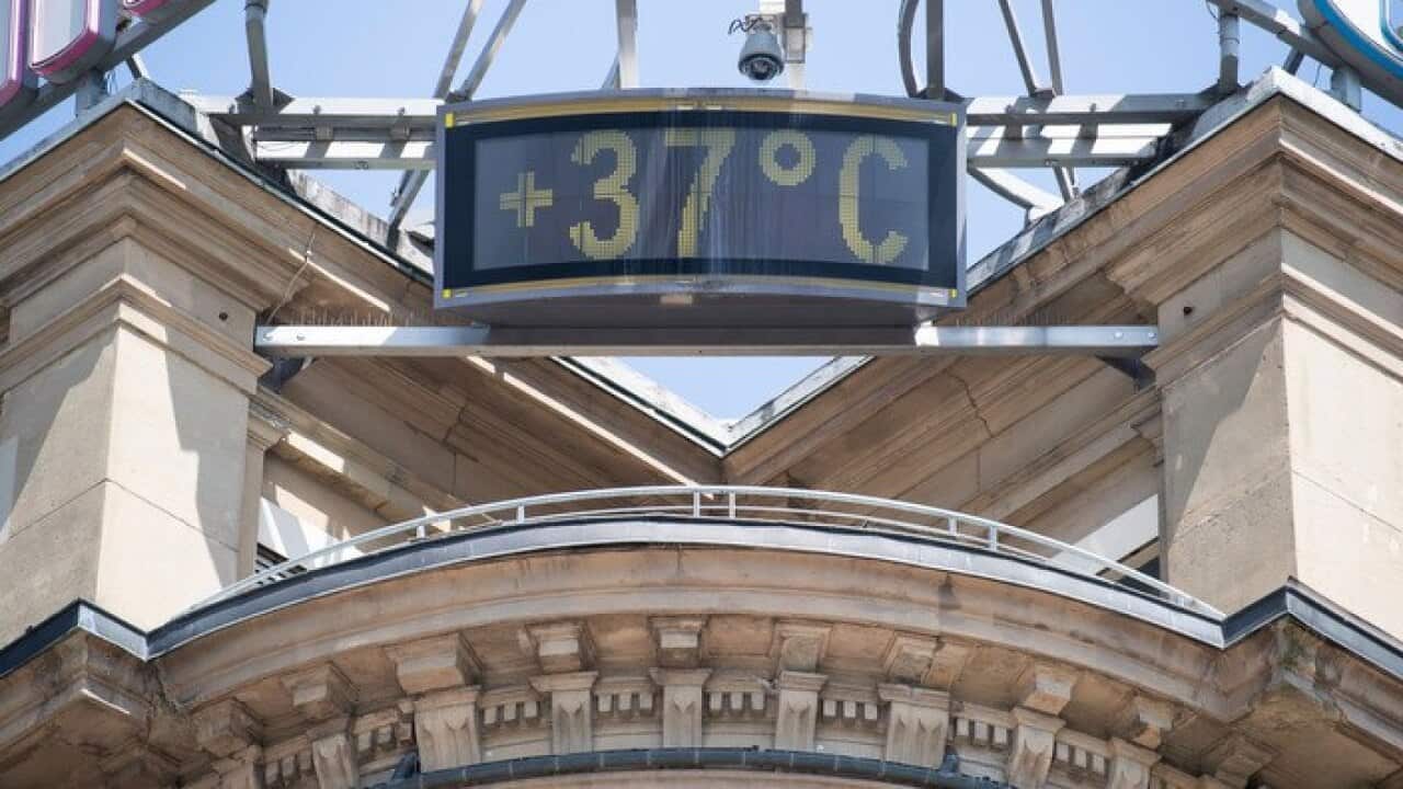 A sign shows 37 degrees Celsius at a building in Stuttgart, Germany