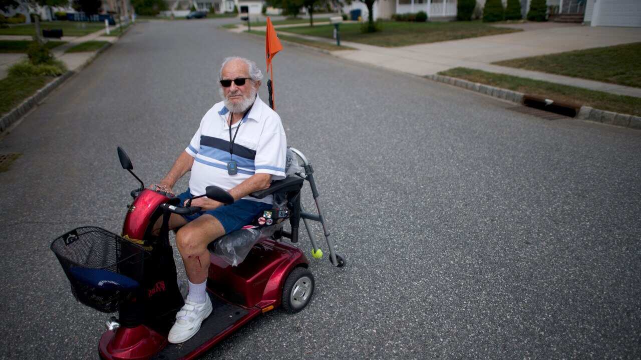 Carl Abrams, 90, a retired Air Force Colonel rides his scooter around the neighborhood in Williamstown, N.J. on Aug. 28, 2019. (Mark Makela/The New York Times)