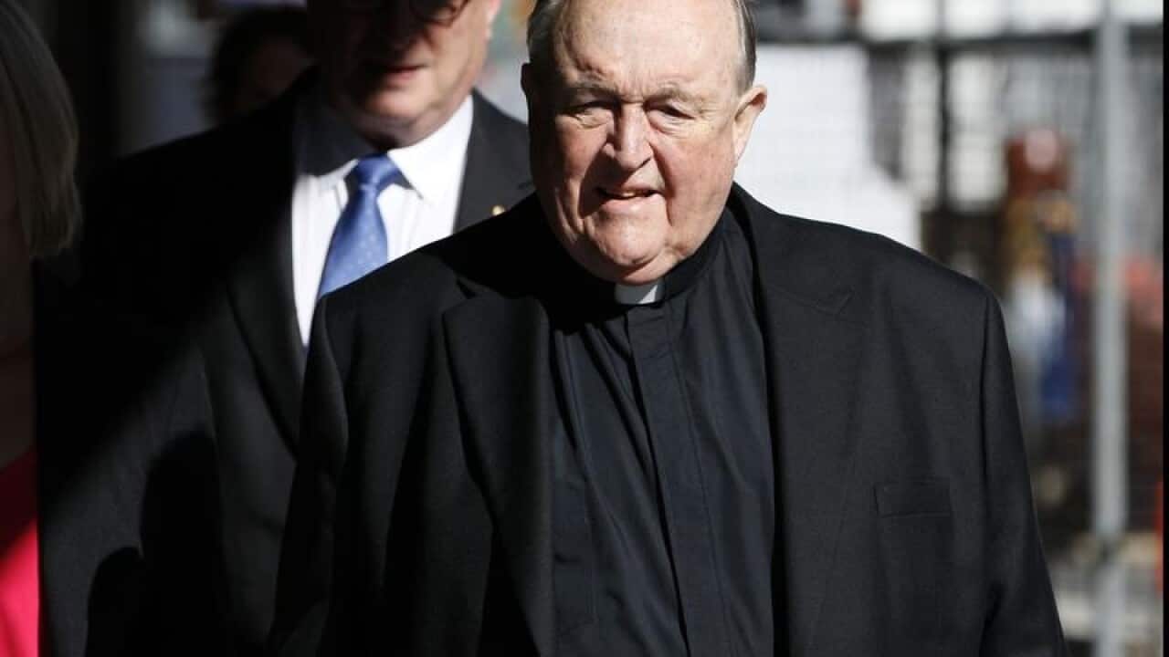 Archbishop Philip Wilson arrives at Newcastle Local Court.