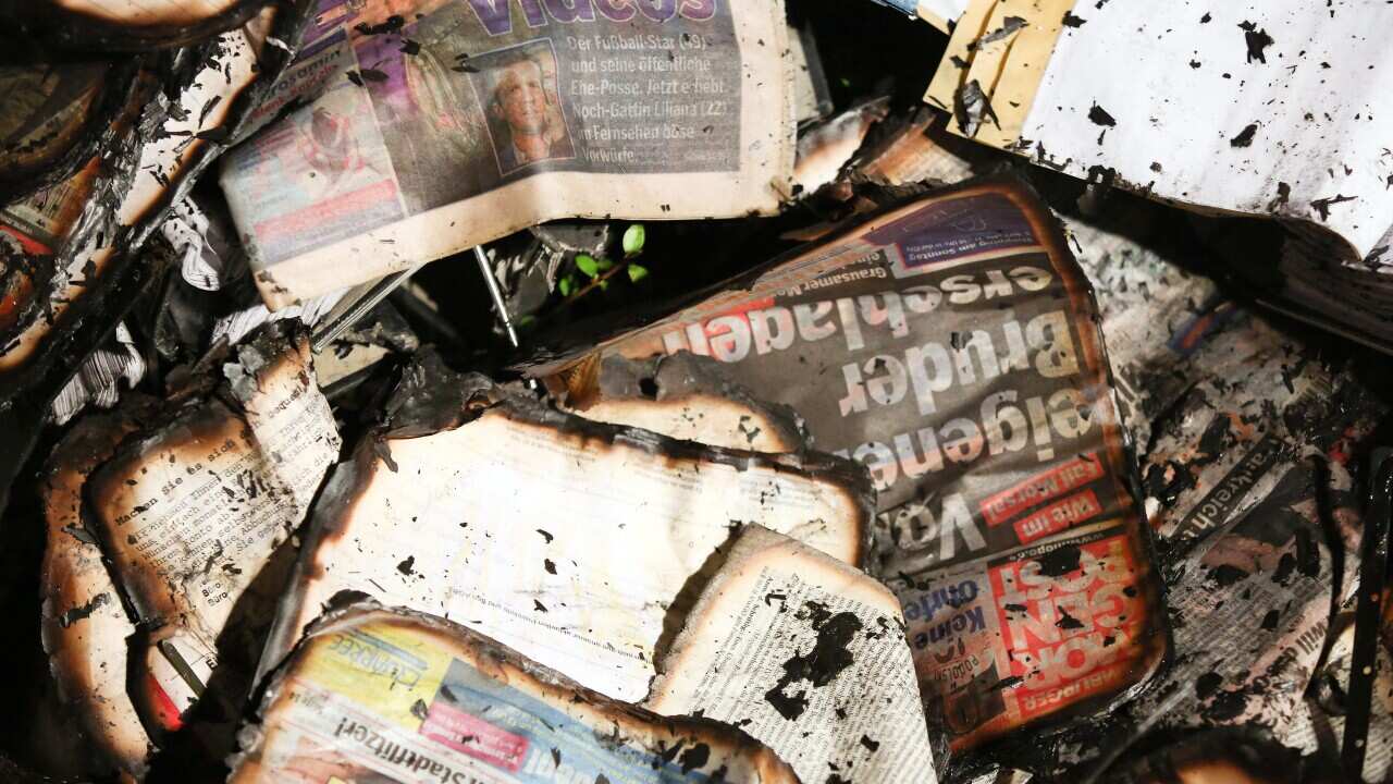 Fire-damaged newspapers at the scene of an arson attack on the headquarters of German daily Hamburger Morgenpost, in Hamburg, Germany. (EPA)