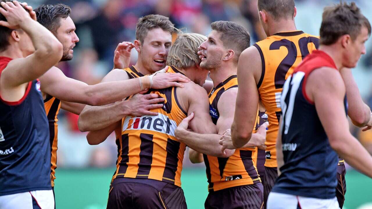 Will Langford of Hawks is congratulated by team-mates