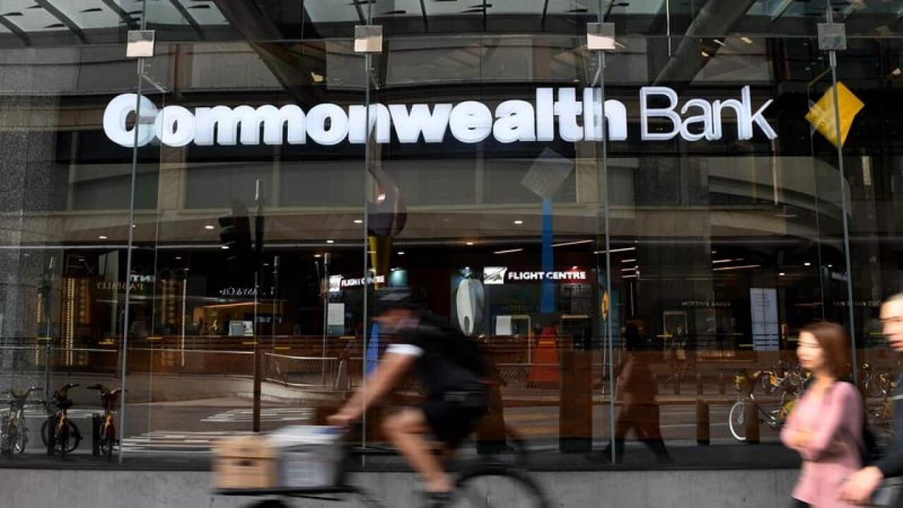 A Commonwealth Bank with pedestrians and cyclist