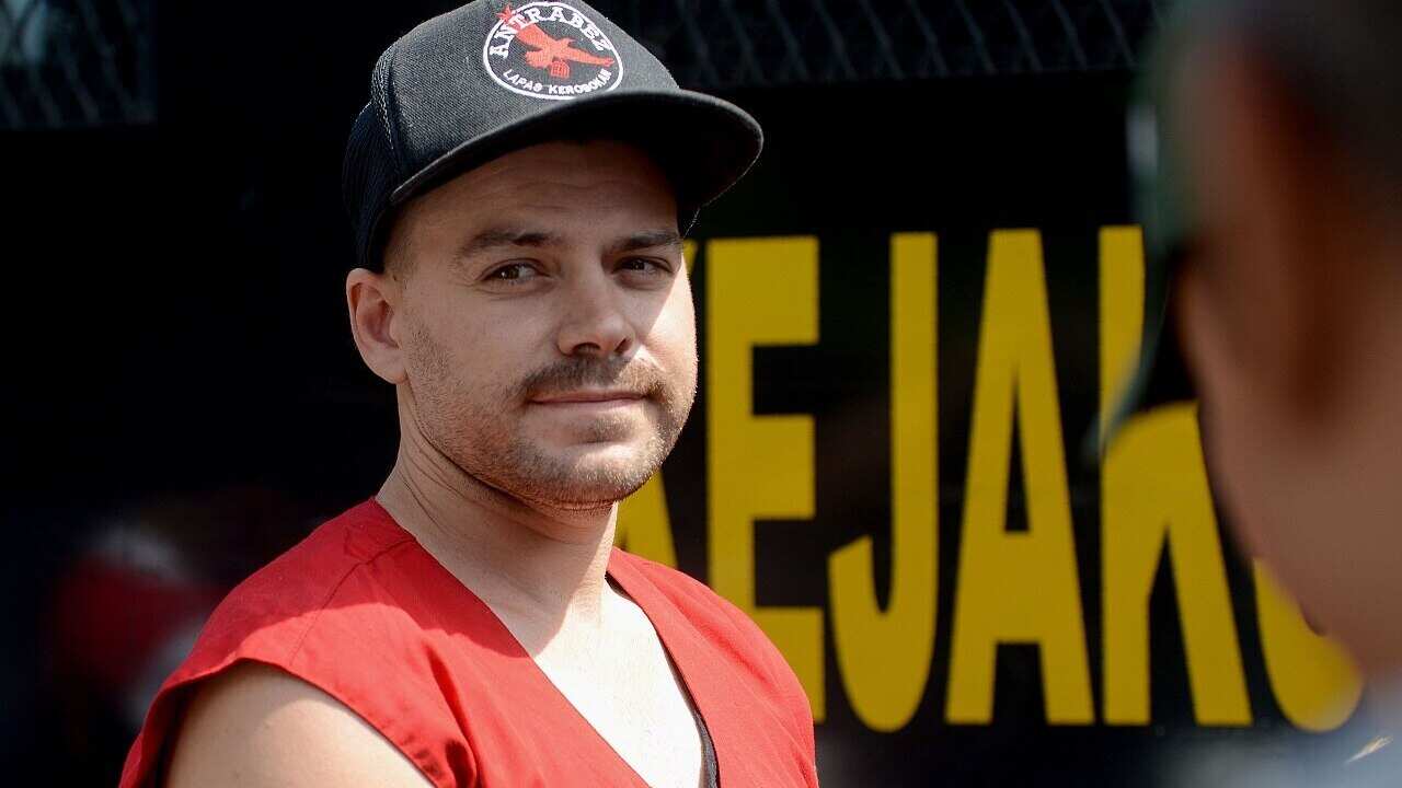 Nicholas Carr arrives at a court for his verdict in Denpasar.