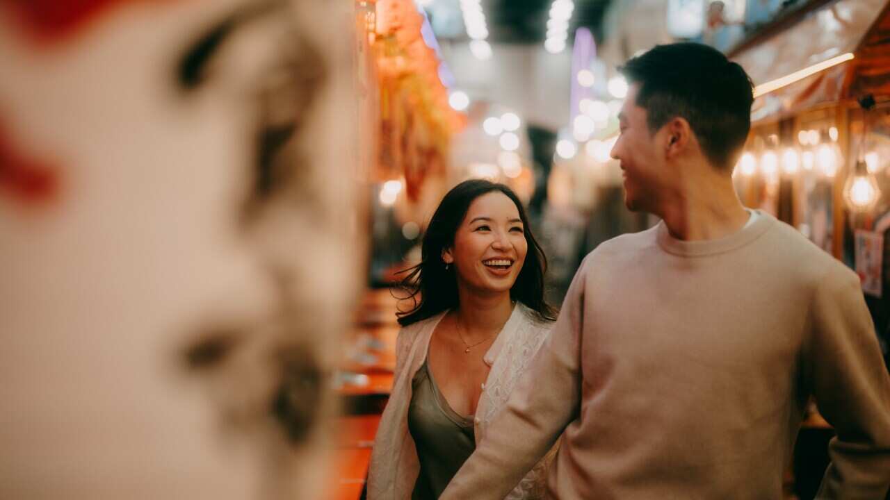 Couple having fun in Tokyo at night